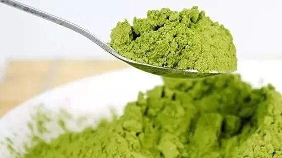 Fine green matcha powder on a spoon