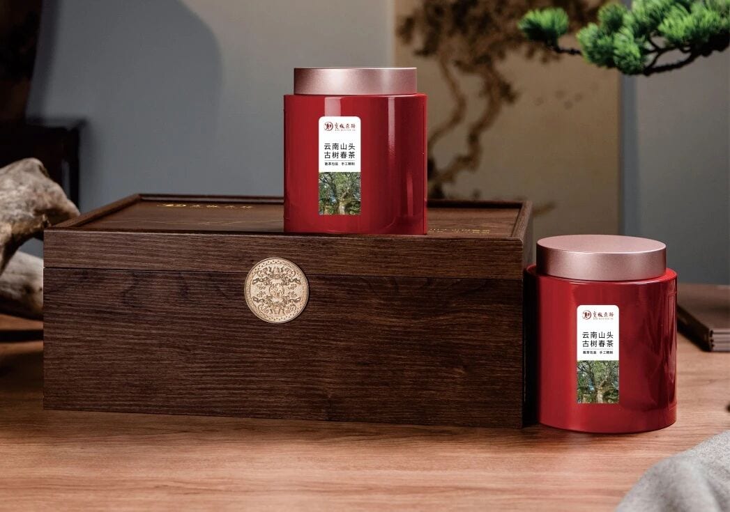 Red Yunnan tea tins presented in a wooden gift box